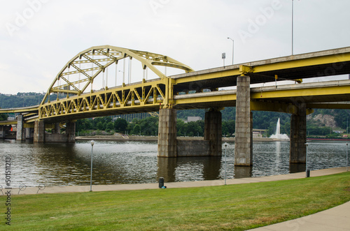 Shot of the Pittsburgh yellow arch Fort Pitt bridge over the Allegheny River on a gloomy day photo