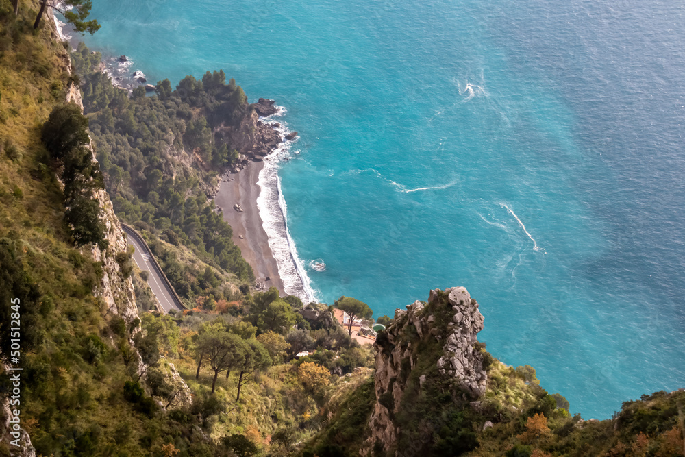 Aerial view from a hiking trail on the coastal driving road of the beautiful scenic Amalfi Coast, Campania, Italy, Europe. Riviera coastline at Mediterranean sea. Panoramic curvy road near Positano