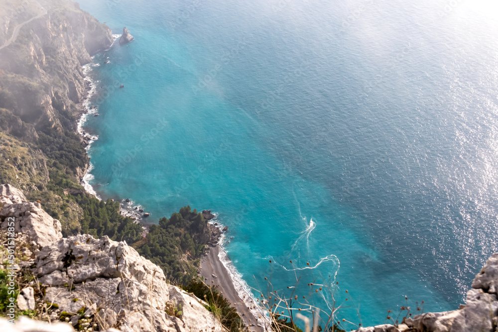 Aerial view from a hiking trail on the coastal driving road of the beautiful scenic Amalfi Coast, Campania, Italy, Europe. Riviera coastline at Mediterranean sea. Panoramic curvy road near Positano