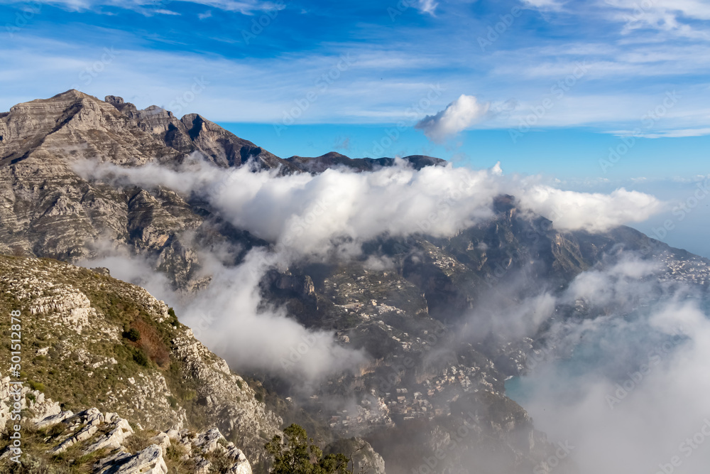 Panoramic view from Monte Comune on cloud covered peaks of Monte Molare, Canino, Caldare, Lattari Mountains, Apennines, Amalfi Coast, Italy, Europe. Hiking trail going to coastal town Positano at sea