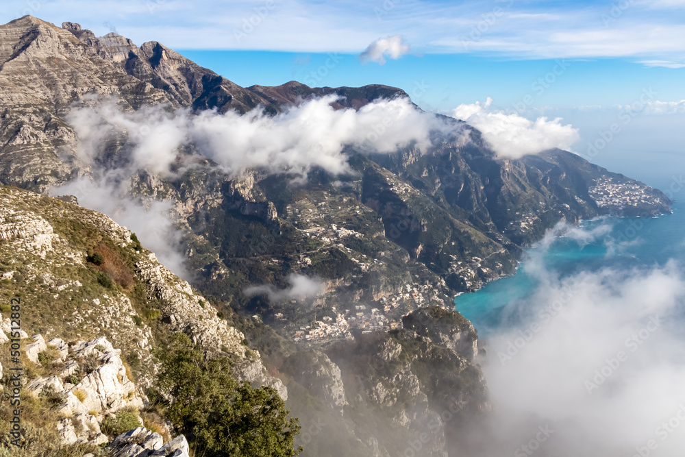 Panoramic view from Monte Comune on cloud covered peaks of Monte Molare, Canino, Caldare, Lattari Mountains, Apennines, Amalfi Coast, Italy, Europe. Hiking trail going to coastal town Positano at sea