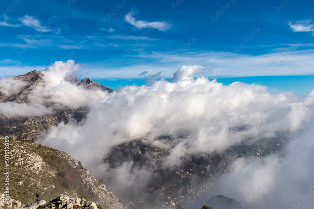 Panoramic view from Monte Comune on cloud covered peaks of Monte Molare, Canino, Caldare in Lattari Mountains, Apennines, Amalfi Coast, Italy, Europe. Hiking trail near the coastal town Positano.