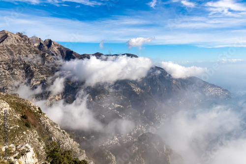 Panoramic view from Monte Comune on cloud covered peaks of Monte Molare  Canino  Caldare  Lattari Mountains  Apennines  Amalfi Coast  Italy  Europe. Hiking trail going to coastal town Positano at sea