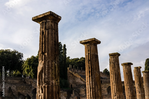 Ruins of antique roman temple in Pompeii, destroyed by eruption of Mount Vesuvius volcano in 79 AD, Naples, Italy. Ancient city of Pompeii. Remain of the forum colonnade. Pompeii archaeological site