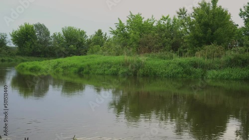 Sunrise on the river in the fog. Evening landscape with the last rays. Beautiful nature in summer