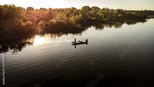Aerial view of a fisherman with a fishing boat in the middle of the lake Grand, Oklahoma at sunset photo