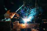 Industrial welder worker welding steel or iron in a factory	
