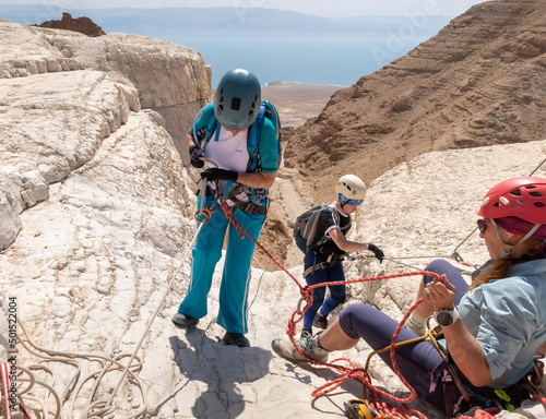 Experienced athletes start the descent with the equipment for snapping in the mountains of the Judean Desert near the Tamarim stream near Jerusalem in Israel photo