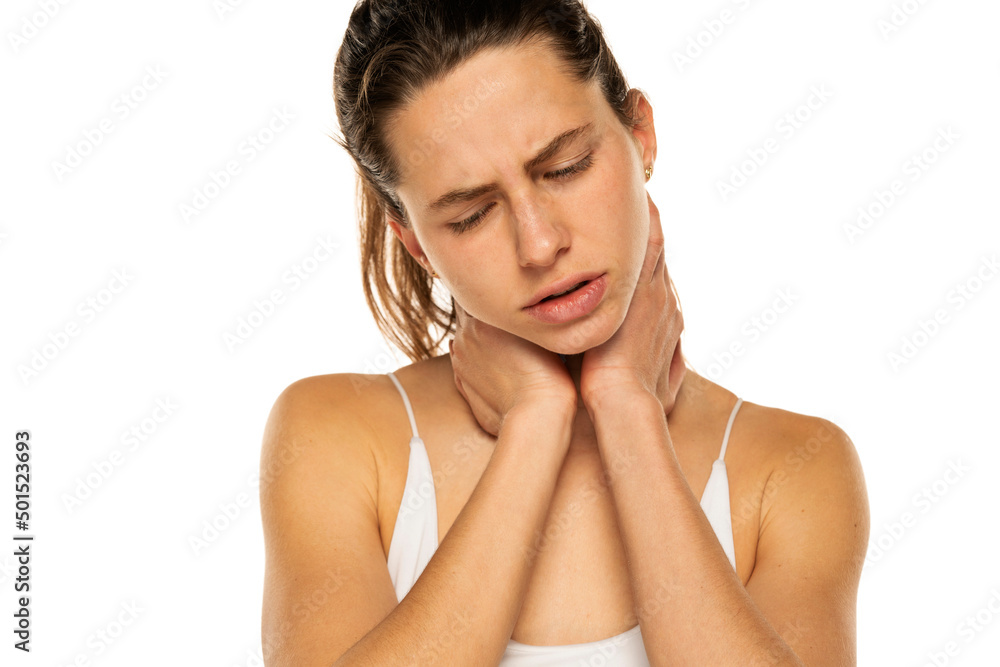 Fototapeta premium Young woman with neck pain on a white background