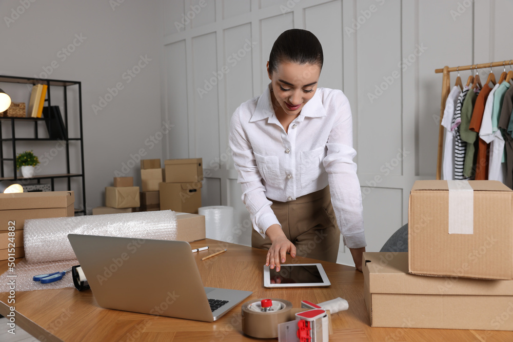 Seller working with tablet in office. Online store Seller working with tablet in office. Online store