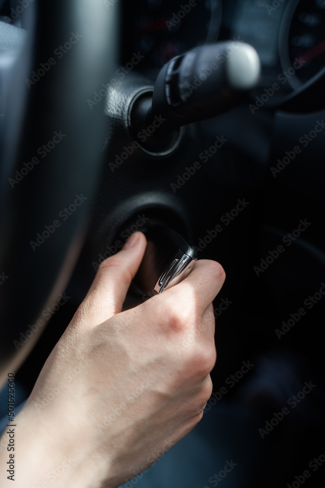 Person jams the car and takes the key out of the ignition. Safety in the car. Hand with key close-up