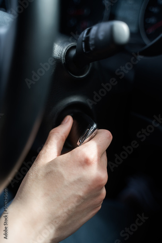 Person jams the car and takes the key out of the ignition. Safety in the car. Hand with key close-up