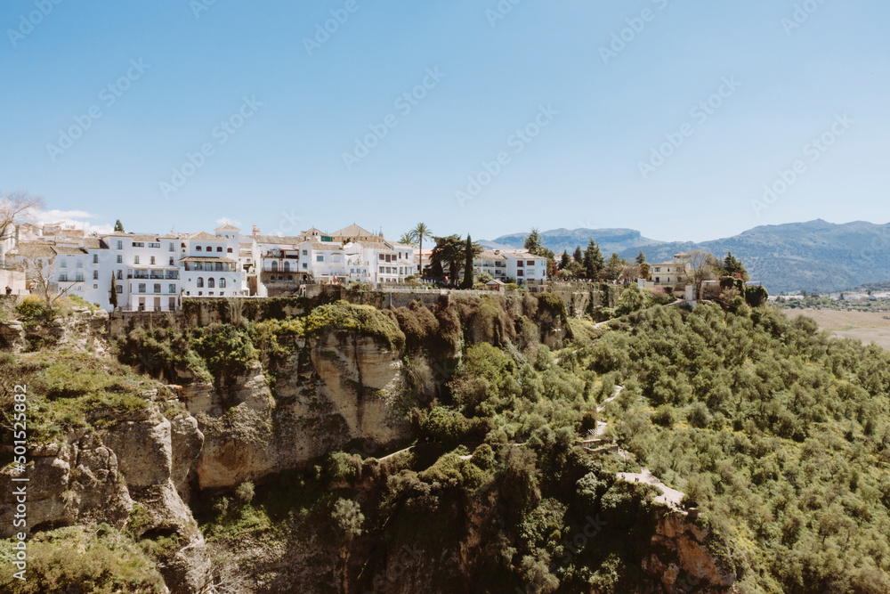 view of part of village of Ronda from elevated point with houses situated on top of large mountain