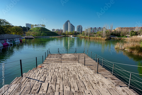 Viewpoint with wooden wharf, a lake and buildings at background in Valencia city photo