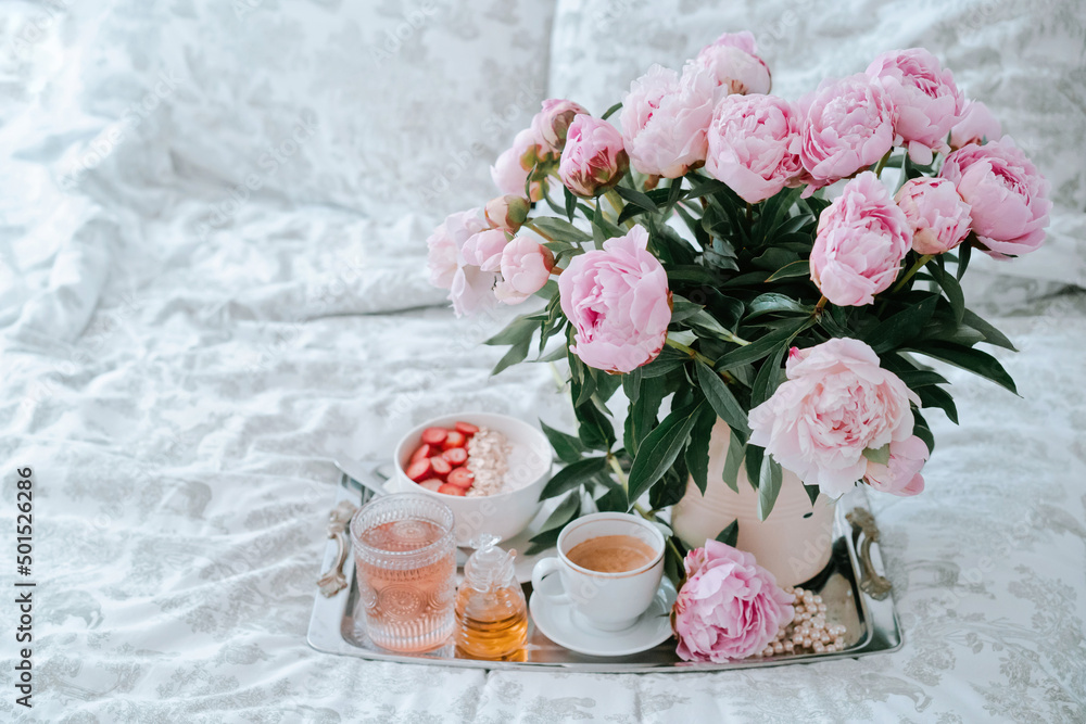 Tray with bouquet of pink peonies flowers and a cup of black coffee and Breakfast in bed, summer morning concept. Healthy food Tray with bouquet of pink peonies flowers and a cup of black coffee and Breakfast in bed, summer morning concept. Healthy food