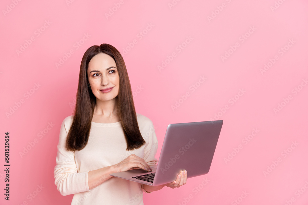 Naklejka premium Photo of beautiful dreamy woman hold laptop home based business thoughtful creative job wear pullover isolated pink color background