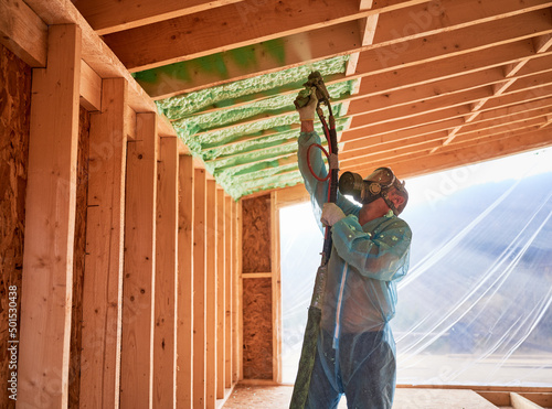 Fotobehang Male builder insulating wooden frame house