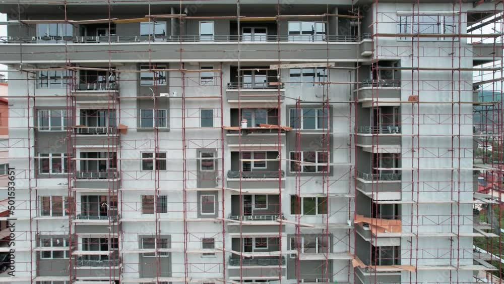 High concrete residential building under construction. Real estate development concept. High concrete residential building under construction. Real estate development concept.