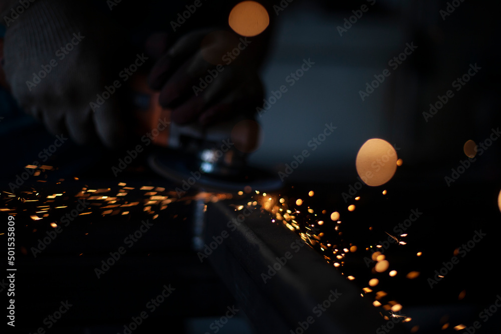 Sparks from the Bulgarian. Metal processing. Steel cutting workshop.