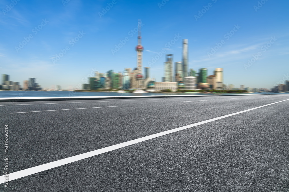 empty asphalt road with city skyline background in china. empty asphalt road with city skyline background in china.