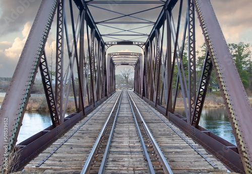 Old iron railway truss bridge built in 1893 crossing the Mississippi river in spring in Galetta, Ontario, Canada
