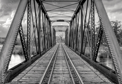 Old iron railway truss bridge built in 1893 crossing the Mississippi river in spring in Galetta, Ontario, Canada
