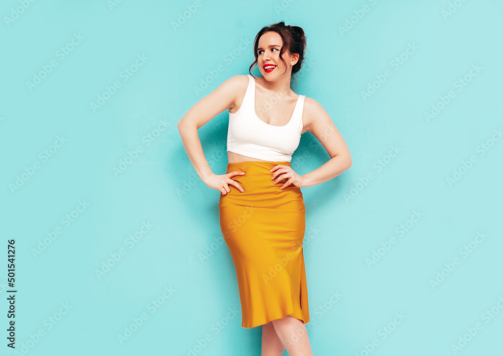 Young beautiful smiling female in trendy summer yellow skirt clothes. Sexy carefree woman posing near wall in studio. Positive model having fun. Cheerful and happy. Isolated Young beautiful smiling female in trendy summer yellow skirt clothes. Sexy carefree woman posing near wall in studio. Positive model having fun. Cheerful and happy. Isolated