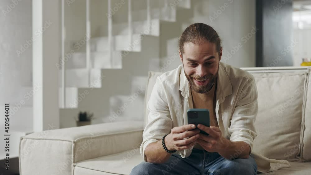 Amazed man saying wow while getting good news on mobile