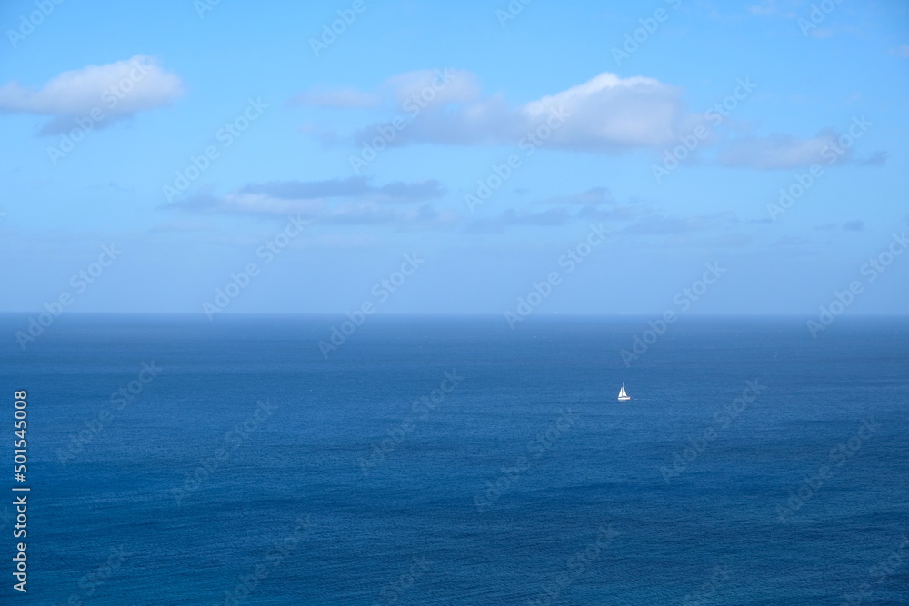 yacht with a white sail in the blue sea off the coast of Malta yacht with a white sail in the blue sea off the coast of Malta
