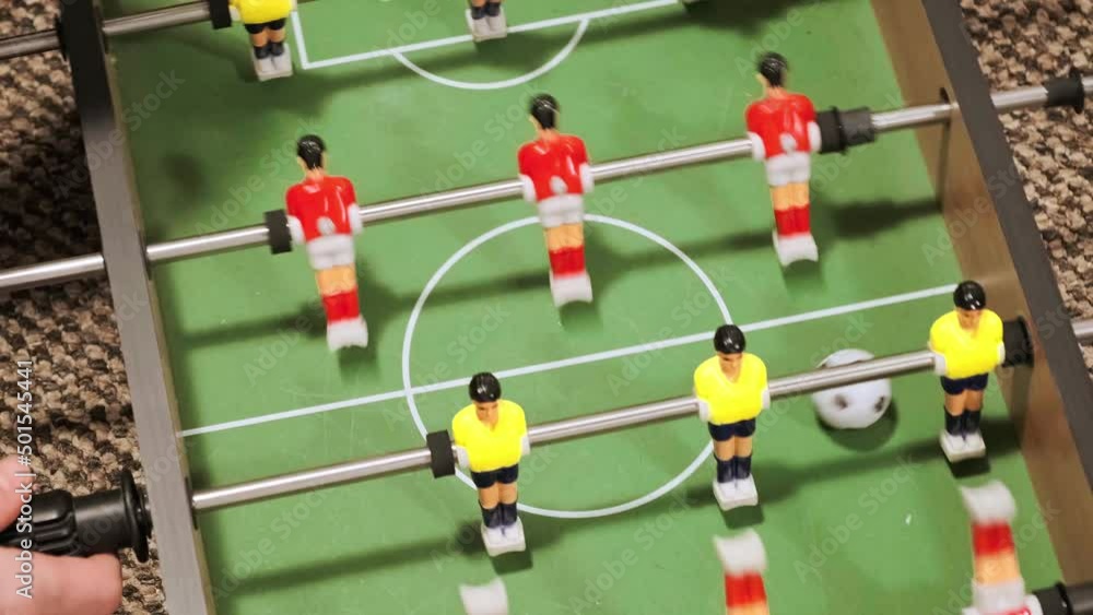 Table football game. Cutting of game moments by different angles view. Happy time of fun family leisure activity at home. Teamwork training. Childhood. Sport toy. Mother play with son. Close-up. Table football game. Cutting of game moments by different angles view. Happy time of fun family leisure activity at home. Teamwork training. Childhood. Sport toy. Mother play with son. Close-up.