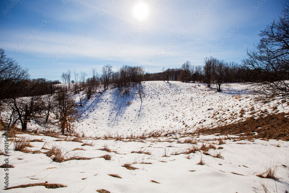 Winter nature landscape. Snow-covered fields and hills. Beautiful winter sunny day. Rural landscape. Winter nature landscape. Snow-covered fields and hills. Beautiful winter sunny day. Rural landscape.