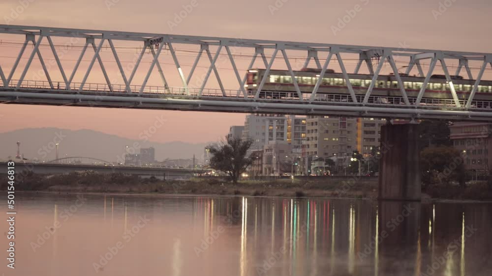 Panoramic video of the lights of a commuter train crossing the bridge reflecting on the water Panoramic video of the lights of a commuter train crossing the bridge reflecting on the water