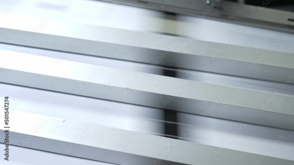 Printing house. Printed sheets of paper are fed to the printing press. Offset printing. Printing house. Printed sheets of paper are fed to the printing press. Offset printing.
