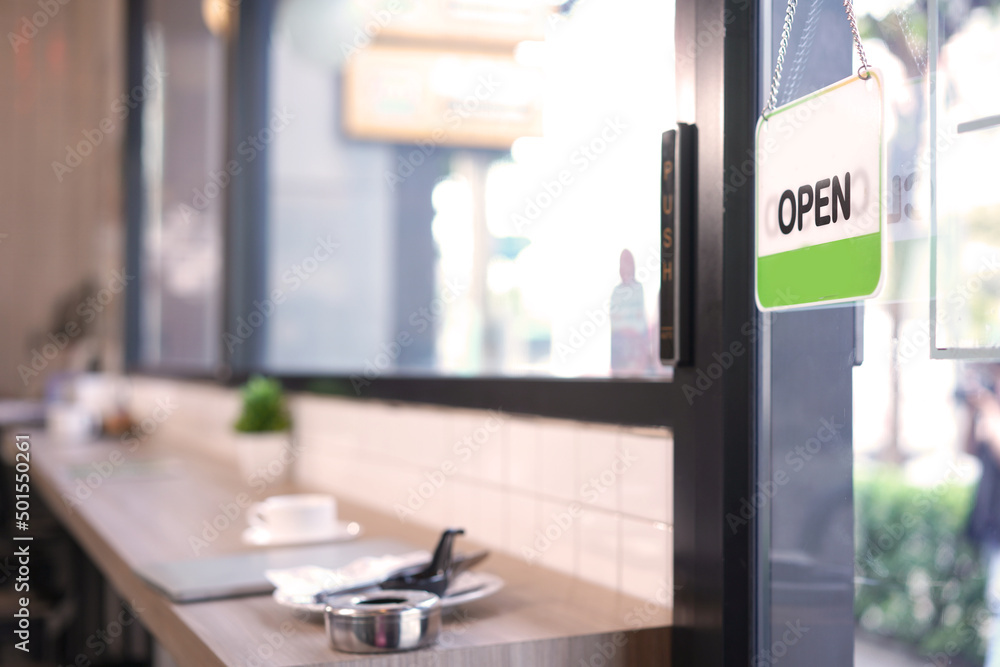 Open and closed flip sign in front of coffee shop and restaurant glass door. Wooden sign with wording of place's status OPEN. Open and closed flip sign in front of coffee shop and restaurant glass door. Wooden sign with wording of place's status OPEN.