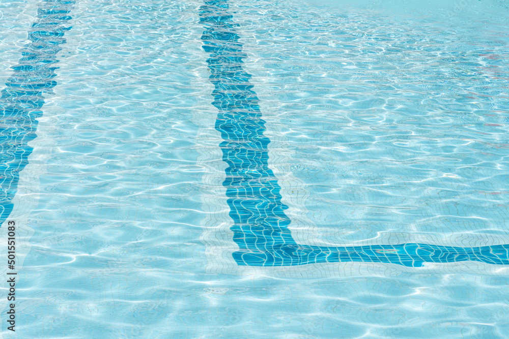 Ripple Clear Blue Water in Swimming Pool with Sun Reflection Texture