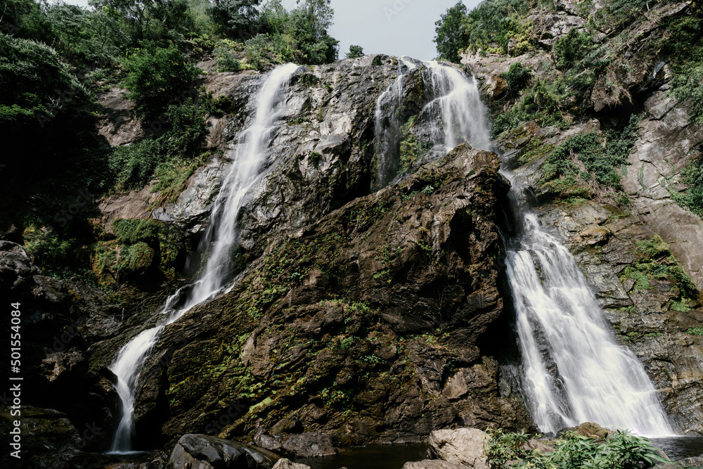 Fototapeta premium Khlong Lan Waterfall, Kamphaeng Phet Province big waterfall in the middle of the perfect forest