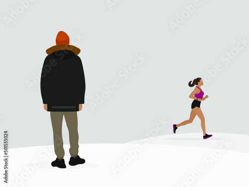 A male character in a jacket and hat stands in the snow and looks at a running female character