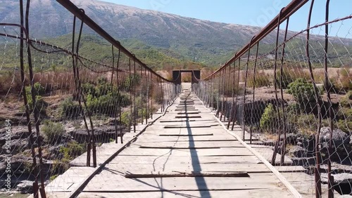 Wooden and Wobbly Suspension Bridge across Vjosa River, Albania - Fly trough photo