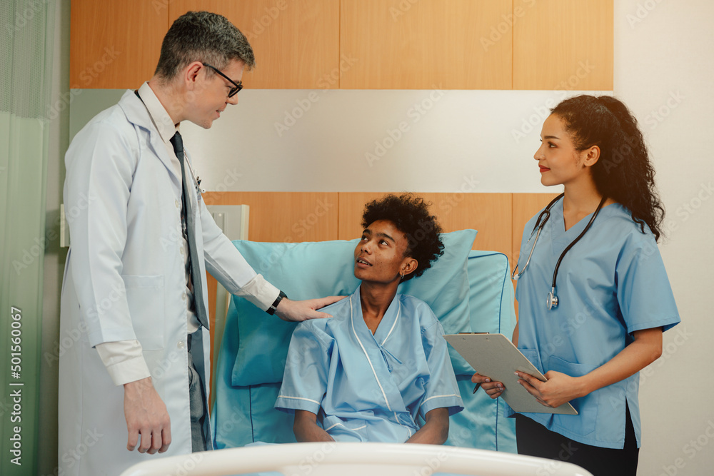 Hospitalized man sitting in bed while doctor checking his pulse. Doctor examining senior male patient in hospital room. Hospitalized man sitting in bed while doctor checking his pulse. Doctor examining senior male patient in hospital room.
