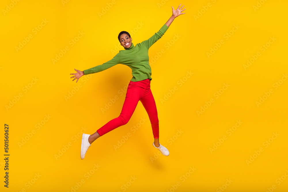 Photo of funny pretty short hair lady dressed green turtleneck walking jumping high isolated yellow color background