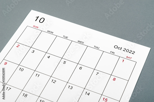 October 2022 calendar sheet on grey background.