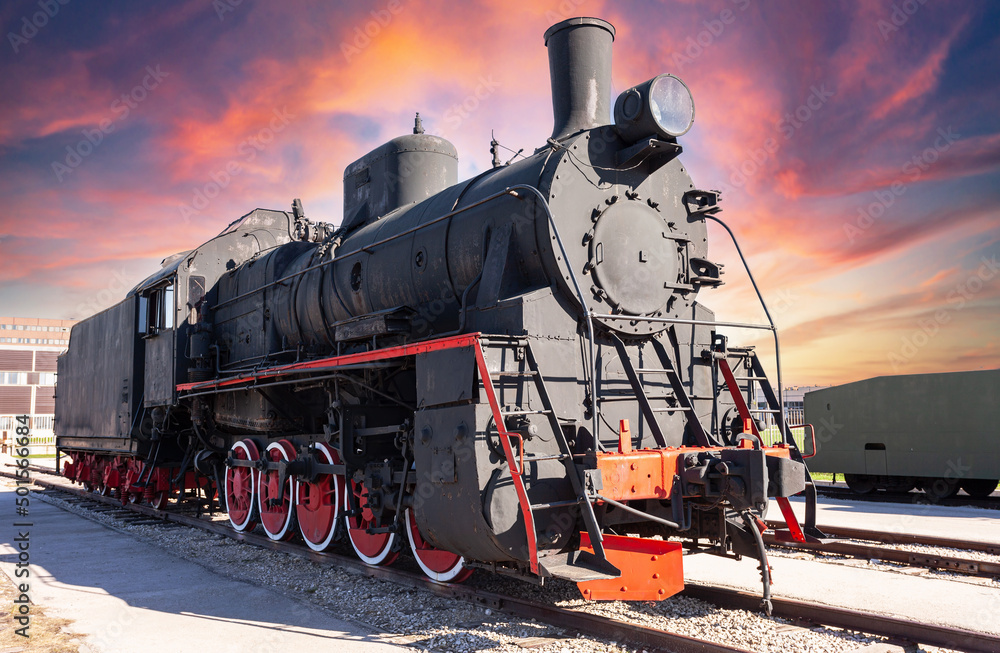 Fototapeta premium Vintage steam locomotive against the sky