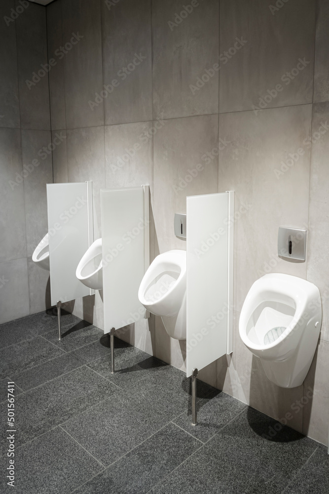 Row of urinal toilet blocks in men public toilet or restroom Stock Photo |  Adobe Stock