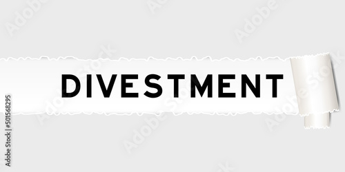 Ripped gray paper background that have word divestment under torn part