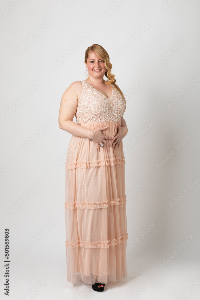 Overweight woman posing in front of the photographer against white background Overweight woman posing in front of the photographer against white background