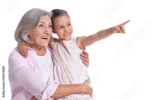 Grandmother hugging with her cute granddaughter isolated on white background