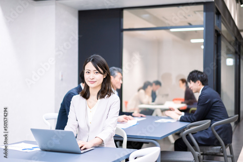 A career woman working at her desk in a shared office © maroke