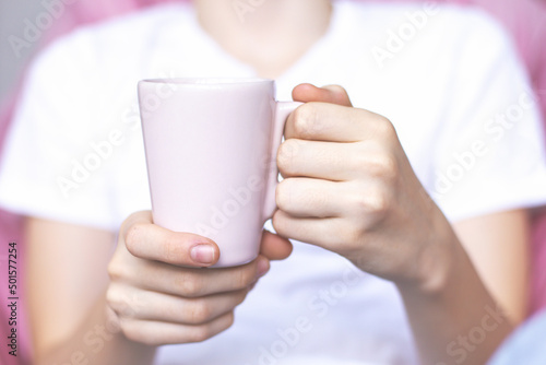  Person holding a cup of coffee.