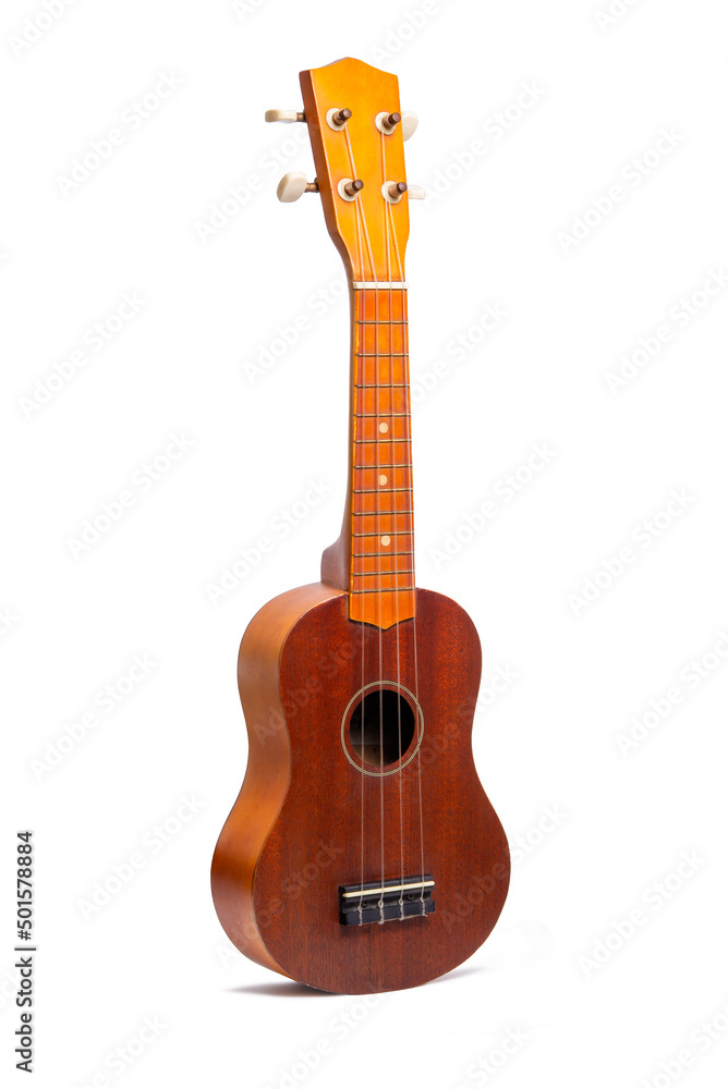 Fototapeta premium The old brown ukulele isolated on a white background.