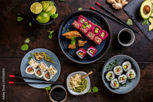 japanese sushi food. Maki ands rolls with tuna, salmon, shrimp, crab and avocado. Top view of assorted sushi. Rainbow sushi roll, uramaki, hosomaki and nigiri. 